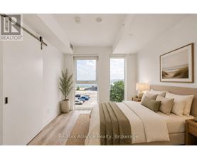A bedroom with a large bed and a view of the outdoors through a window.
