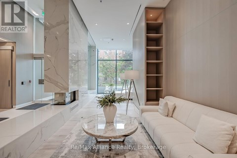 A modern living room with a white sofa and a marble floor.