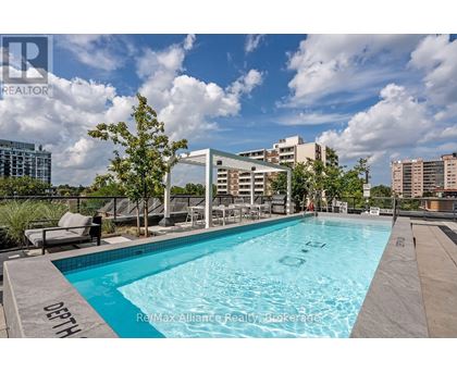 A swimming pool with the words "ReMax Alliance Realty Brokerage" written on the edge.