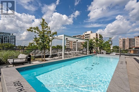A swimming pool with the words "ReMax Alliance Realty Brokerage" written on the edge.