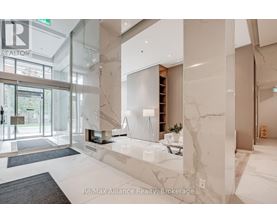 A spacious lobby with marble floors and a glass wall.