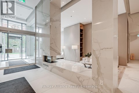 A spacious lobby with marble floors and a glass wall.