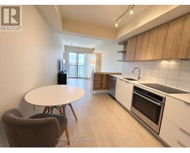 A kitchen with a table and chairs in the foreground and a window in the background.