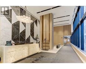 A reception area with a marble counter and a large window.