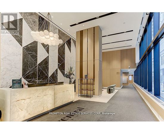 A reception area with a marble counter and a large window.