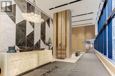 A reception area with a marble counter and a large window.