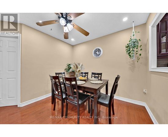 A dining room with a table set for six people.