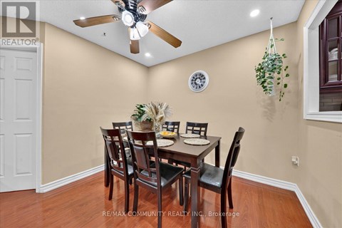A dining room with a table set for six people.