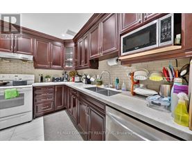 A kitchen with brown cabinets and a white stove top oven.