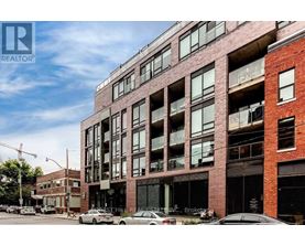A large red brick building with many windows and balconies.