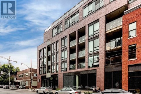 A large red brick building with many windows and balconies.