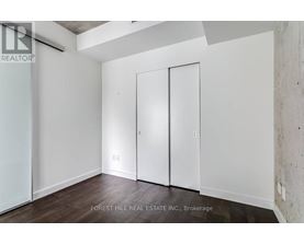 A room with a white wall and a white door.