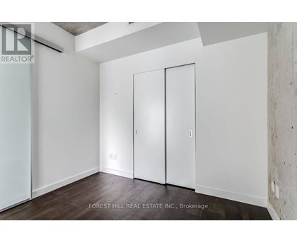 A room with a white wall and a white door.