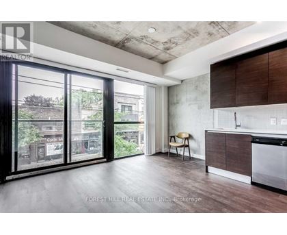 A modern kitchen with a dining chair and a view of the city.