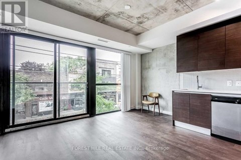 A modern kitchen with a dining chair and a view of the city.