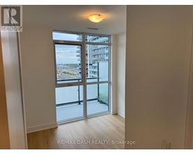 A room with a sliding glass door leading to a balcony.
