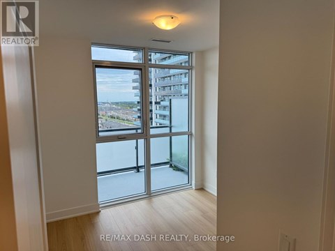 A room with a sliding glass door leading to a balcony.