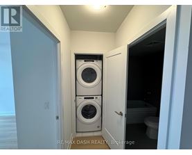 A laundry room with a washer and dryer stacked on top of each other.