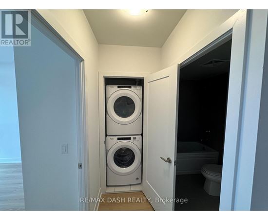A laundry room with a washer and dryer stacked on top of each other.