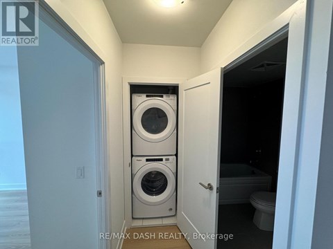 A laundry room with a washer and dryer stacked on top of each other.