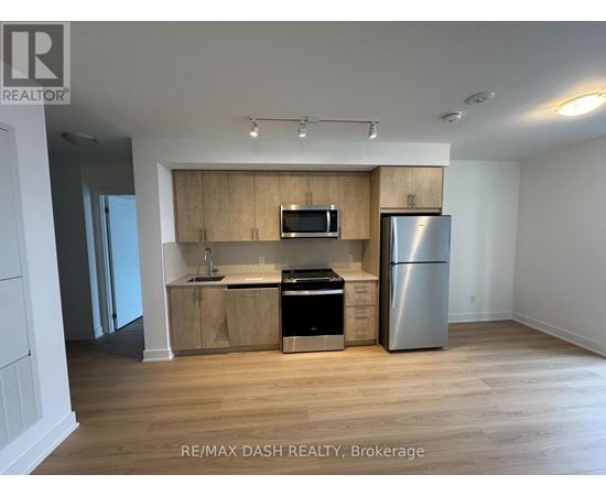 A kitchen with wooden cabinets and stainless steel appliances.