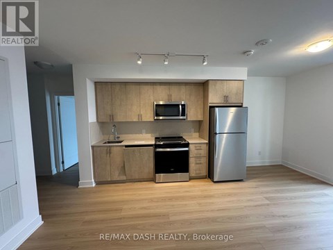 A kitchen with wooden cabinets and stainless steel appliances.