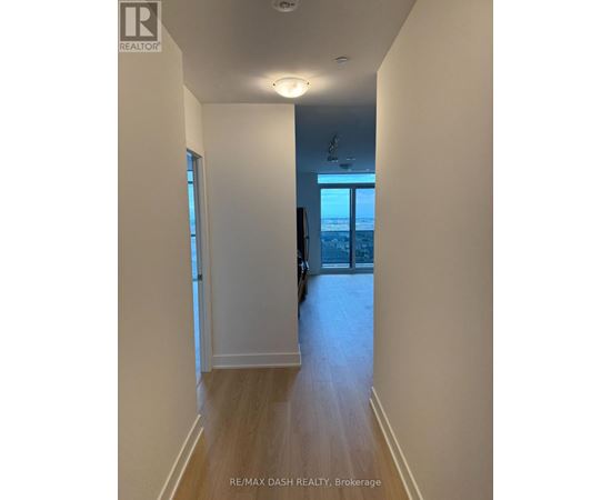 A hallway with a door leading to a balcony.