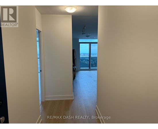 A hallway with a door leading to a balcony.