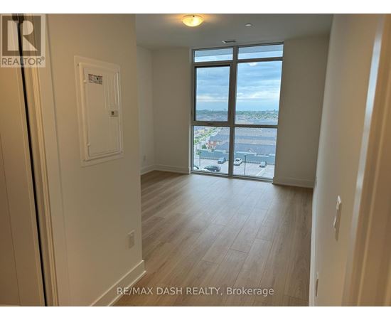 A room with a view of the city through a large window.