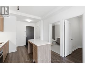 A kitchen with a white counter top and wooden cabinets.