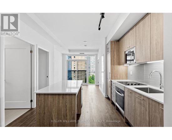 A modern kitchen with wooden cabinets and a white countertop.