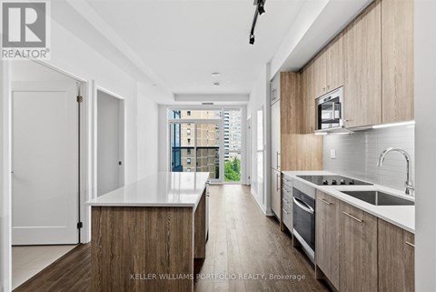 A modern kitchen with wooden cabinets and a white countertop.