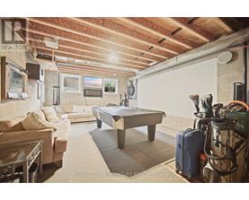 A room with a pool table and a couch.