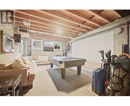 A room with a pool table and a couch.