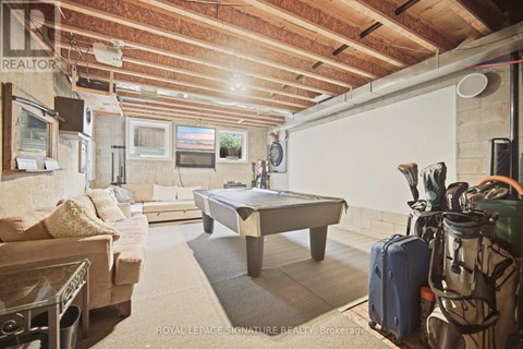 A room with a pool table and a couch.