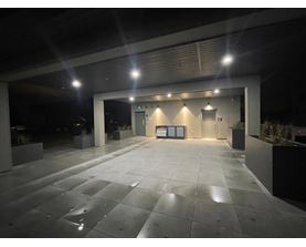 A spacious, empty parking garage with a concrete floor and walls.