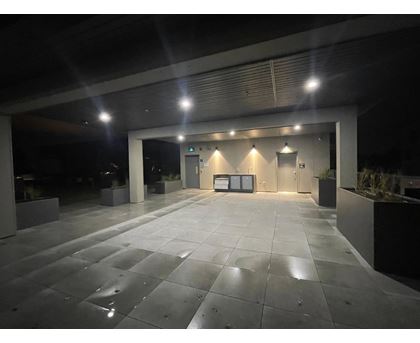 A spacious, empty parking garage with a concrete floor and walls.