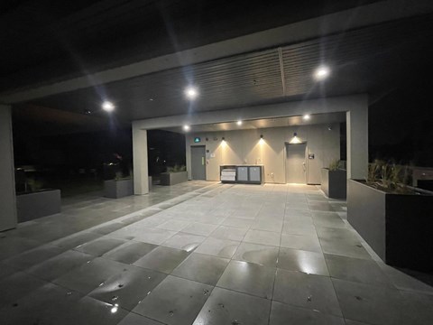 A spacious, empty parking garage with a concrete floor and walls.