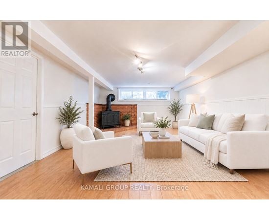 A living room with a white couch, a coffee table, and a fireplace.