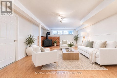 A living room with a white couch, a coffee table, and a fireplace.