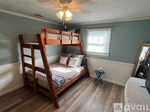A bedroom with a bunk bed and a small table.