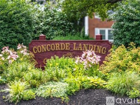 A sign that says Concorde Landing is surrounded by plants.