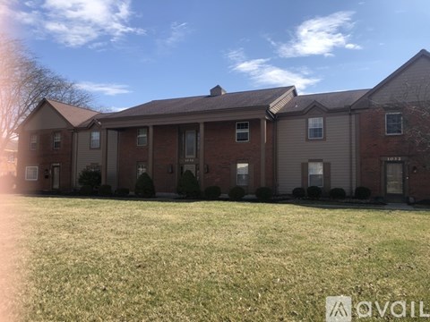 A row of houses with a grassy front yard.
