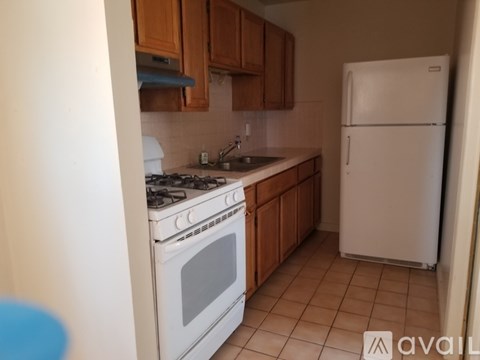 A kitchen with a white fridge and white stove.