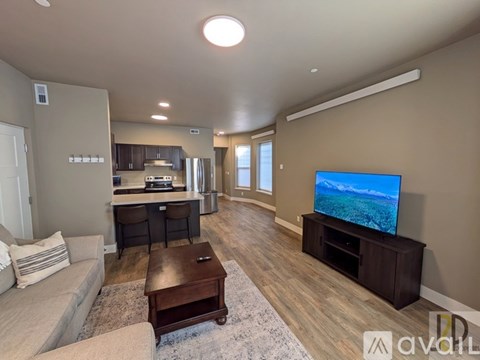 A living room with a television and a couch.