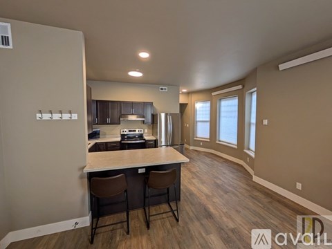A kitchen with a bar area and chairs.