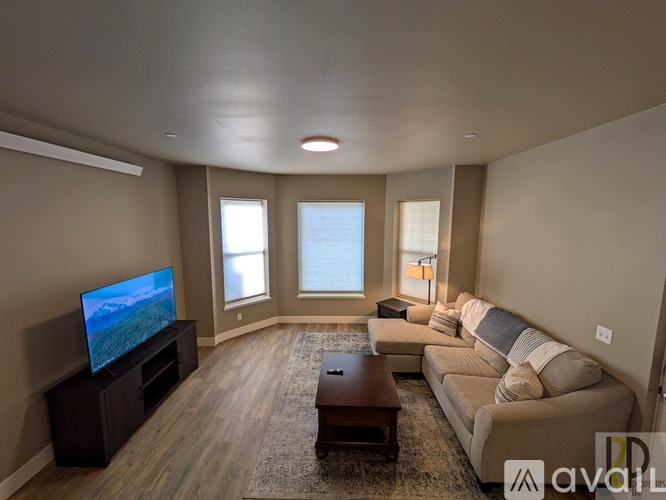 A living room with a television, couch, and coffee table.