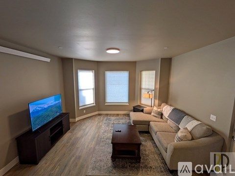 A living room with a television, couch, and coffee table.