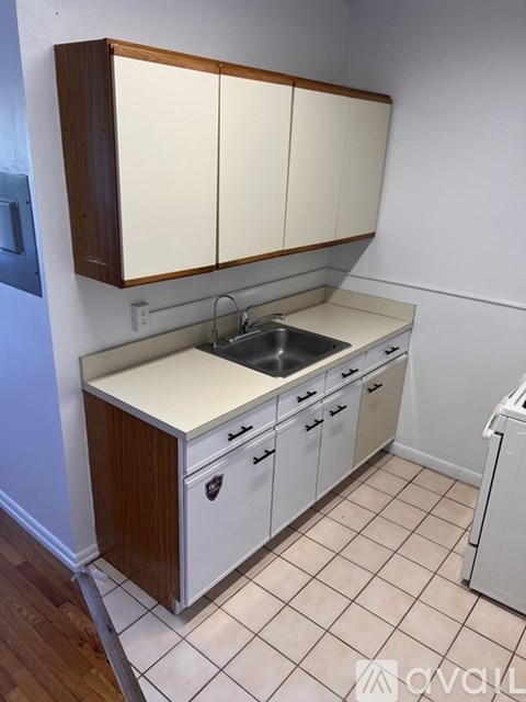 A kitchen with white cabinets and a wooden top.