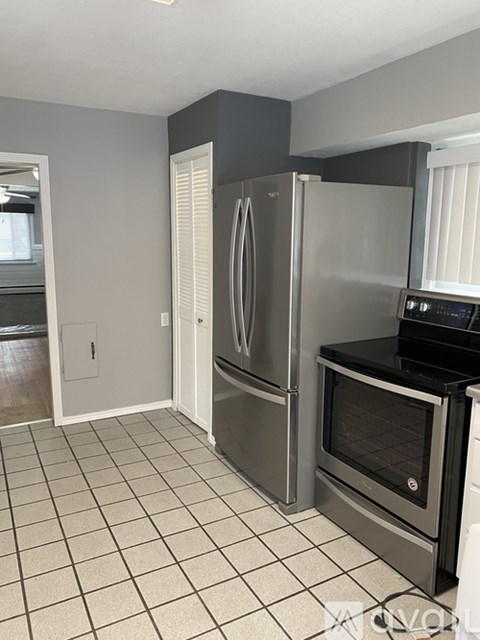 A kitchen with a stainless steel refrigerator and oven.